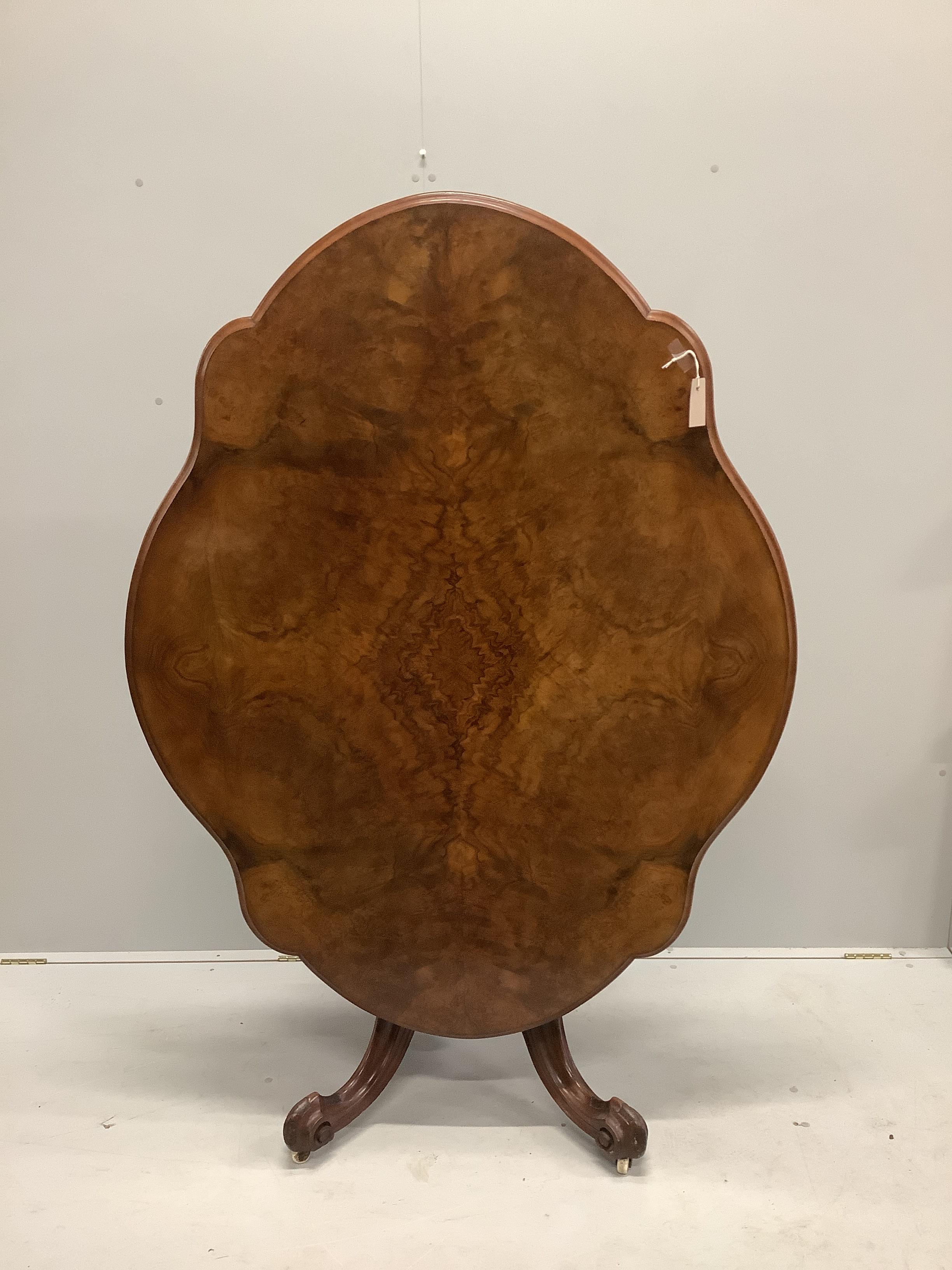A Victorian burr walnut shaped oval tilt top loo table with quarter veneered top, width 146cm, depth 110cm, height 74cm